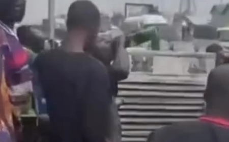 Bystanders drink beer from crashed truck in Lagos